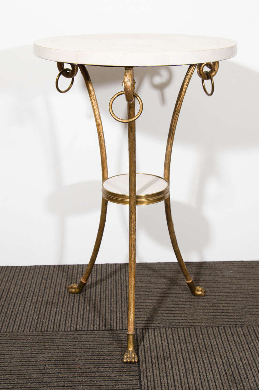A French circa 1940s gilded bronze and shagreen occasional table with tripod base and paw feet. Good vintage condition with age appropriate wear and patina.