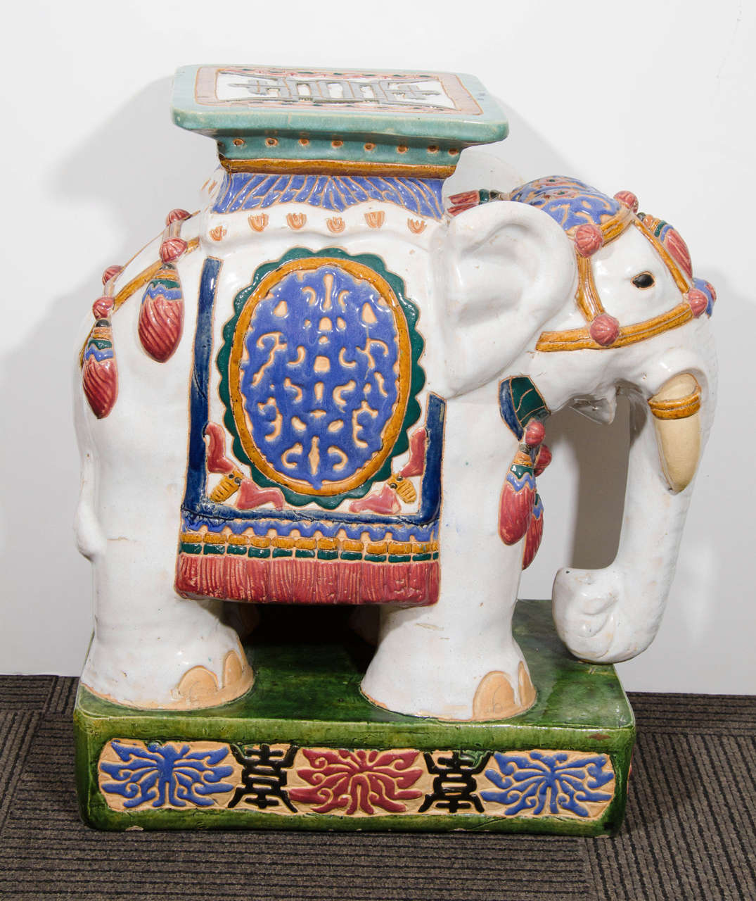 A vintage pair of decorative Asian inspired ceramic elephant garden seats or stools. Can also be used as end or side tables if you add glass tops. Good vintage condition with age appropriate wear. There is a chip to one seat and a few nicks to the