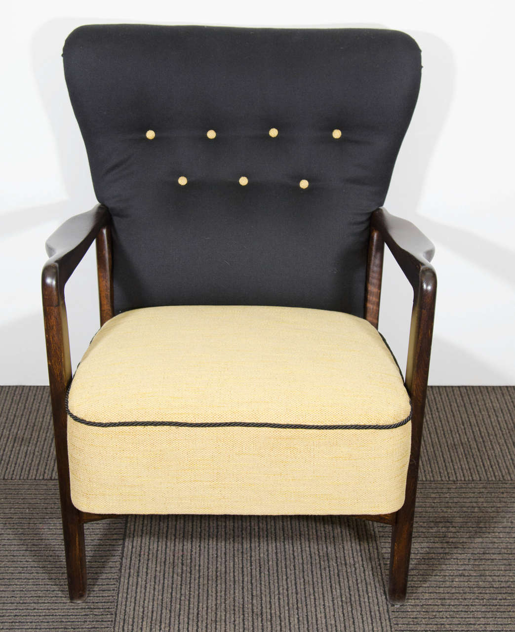 A vintage pair of Fritz Hansen two-tone black and yellow button tufted easy chairs.  Stamped by Fritz Hansen