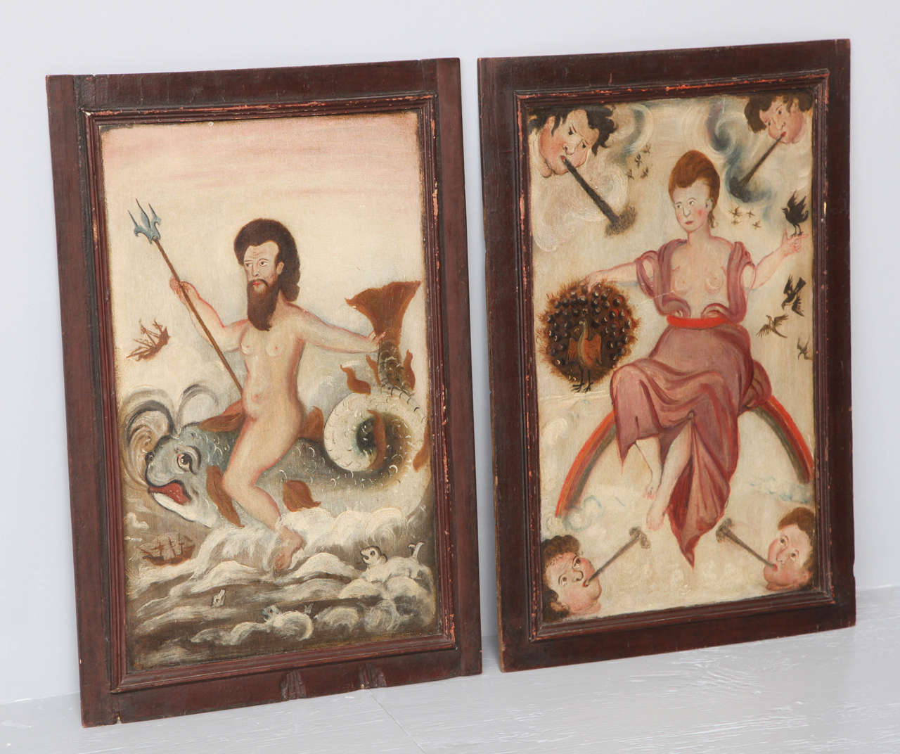 Unusual pair of 18th century folk art painted panels depicting Poseidon and Hera, he shown holding his trident sitting astride a dolphin and she sitting beside a peacock with heralds trumpeting in the corners. Possessing beautiful colors and having