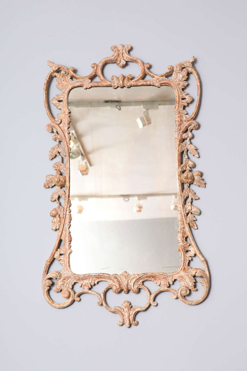 Fine George III Rococo mirror, the later cresting over rectangular frame decorated with rocaille, foliate and scroll carving, the whole with lovely dry scraped original gilt surface.