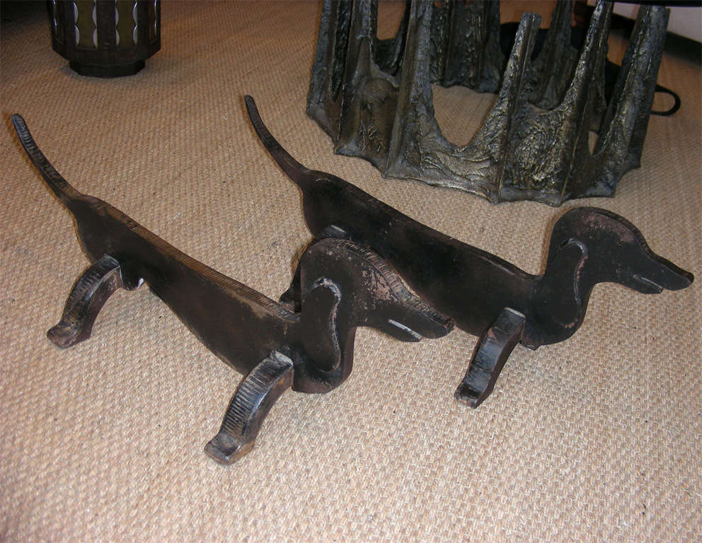 Two 1950s cast iron dachshund- shaped andirons.