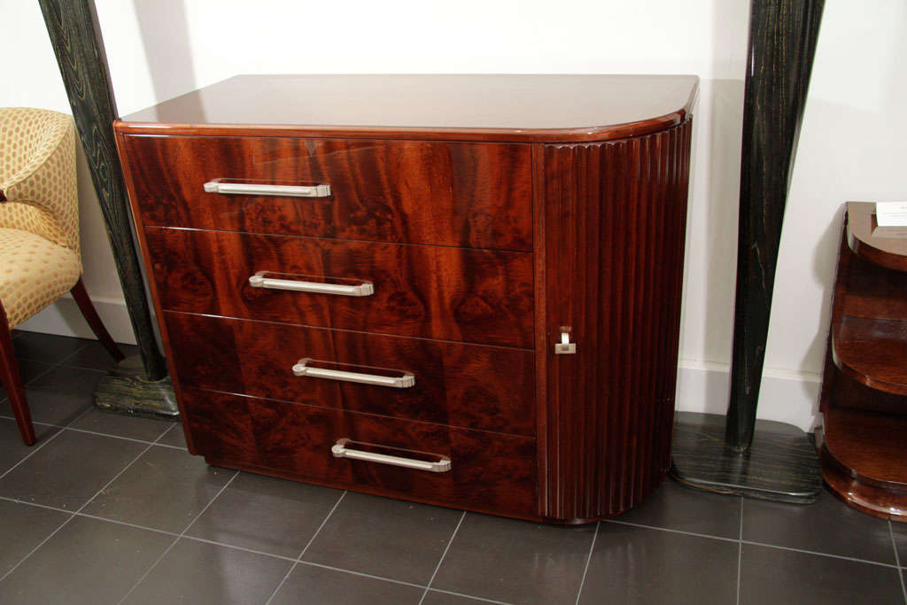 Machine Age deco asymmetric low chest of drawers in walnut and burl; in the style of Deskey, circa 1930s.