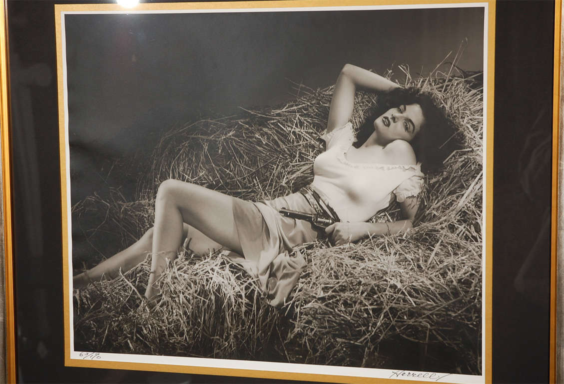 A custom framed limited edition silver gelatin print of actress Jane Russell.  This piece numbered 63/190 is signed in pen by George Hurrell and was printed in the 1970's though originally shot for 