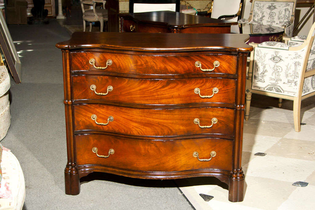 Pair of Mahogany Chests, the serpentine top over a conforming case fitted with four graduating drawers, raised on bracket feet.