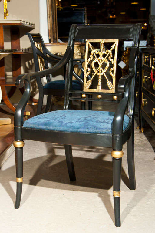 A set of Eight Maison Jansen style ebonized and paint decorated arm chairs. All have French back-splat design with arrows running through a ribbon bow. Supported by a bamboo style leg. CAN BUY ONE.