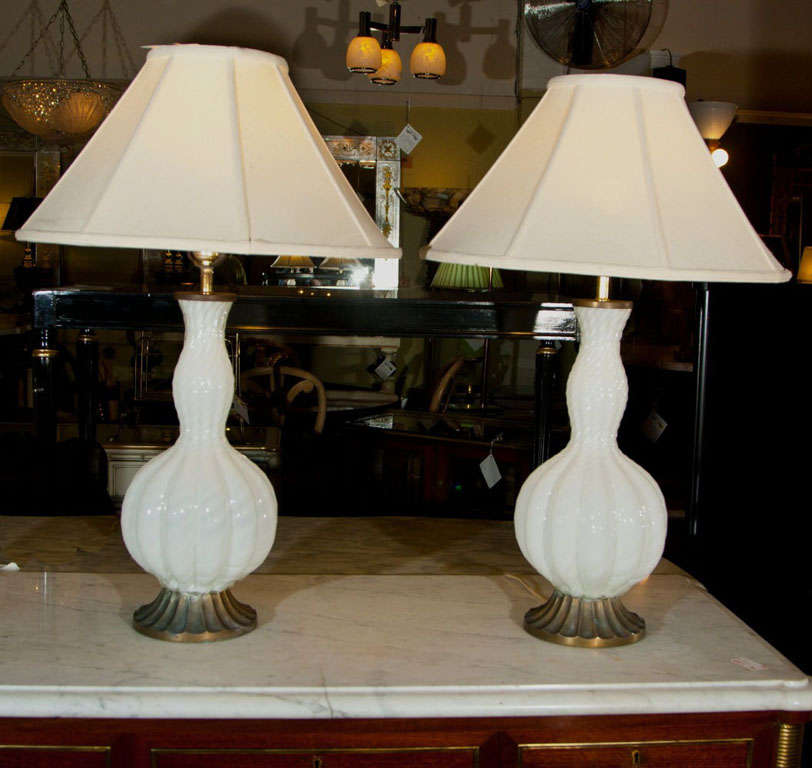 A lovely pair of white Murano glass lamps with brass bases. Shades not included.
