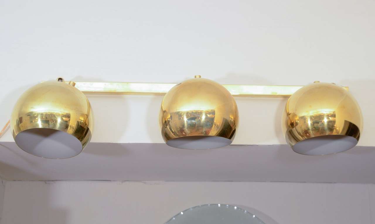Single linear brass sconce with adjustable lights.