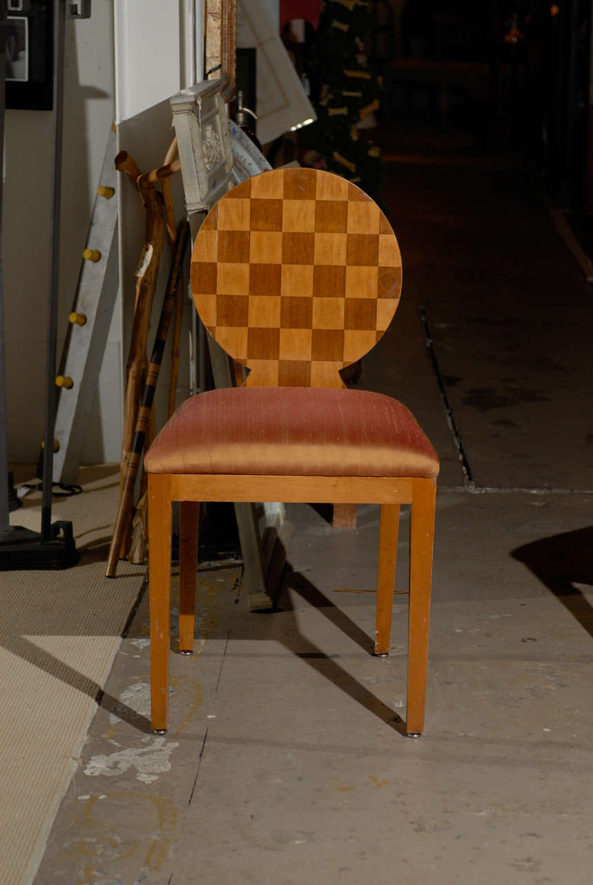 Pair of the Paris Hall chairs by Donghia.  The checkerboard on the inside and outside circular chair back is composed of birch and walnut veneers, and the edge is inlaid with an ebony and walnut chevron detail.  The upholstered seat rests on tapered