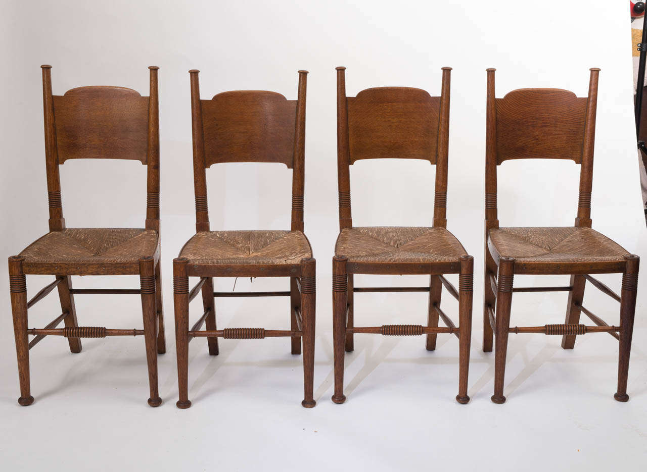 A set of four Arts and Crafts Elm Chairs by William Birch.
The back supports with bulbous shaped finials.
Carved ring decoration.
Original Rush seats.
English.
Circa 1890.
92 cms h x 42 cms w x 40cms d