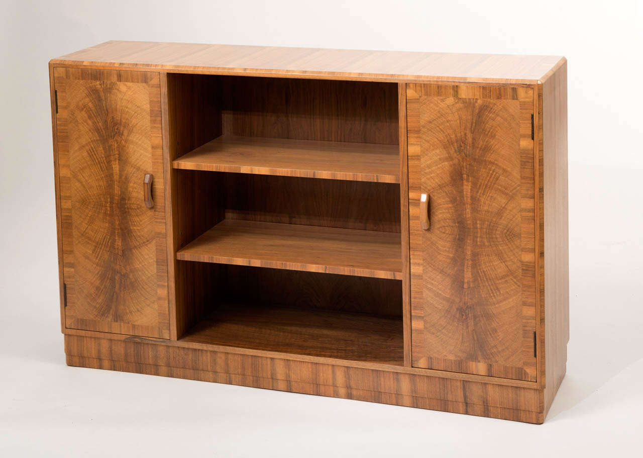 A Walnut Bookcase by Heals of London.
English
Circa 1930
Ivorine Label with maker's mark.
88 cms high x 130cms long x 33 cms deep