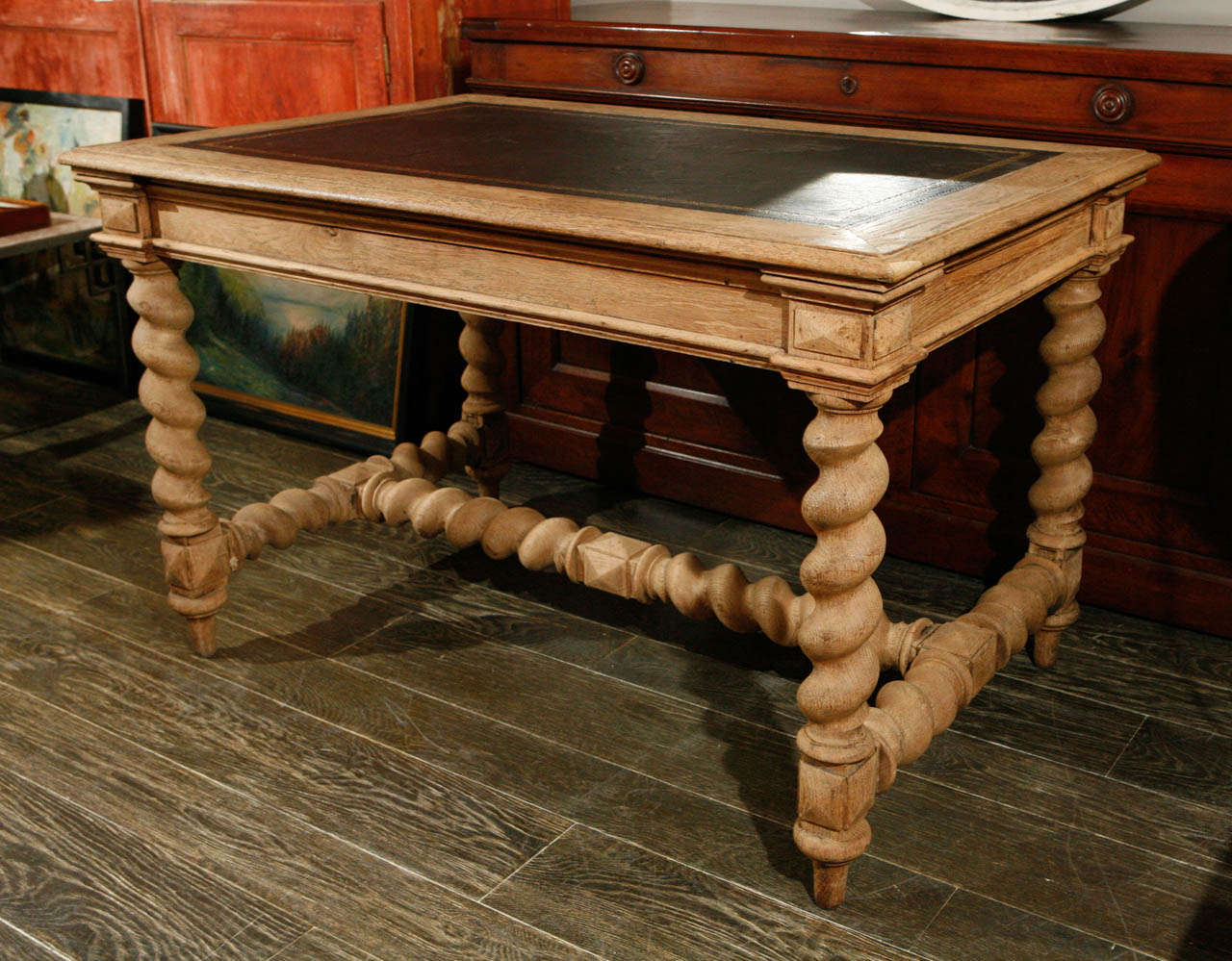 A 19th c. writing table in bleached oak with black leather top.