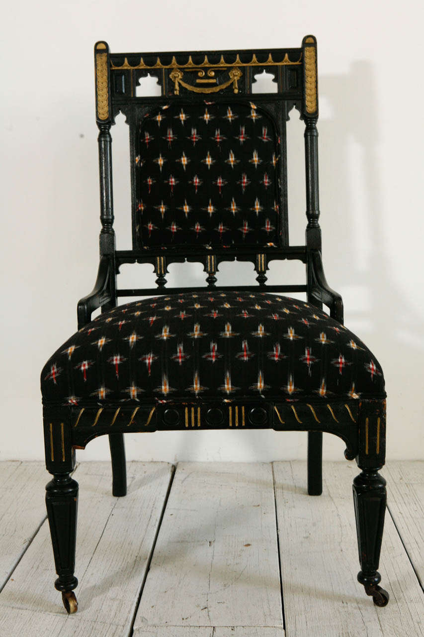 Black accent chair on casters.