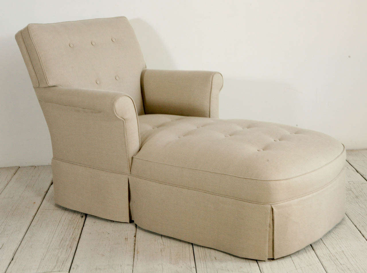 Rolled arm and skirted chaise lounge.