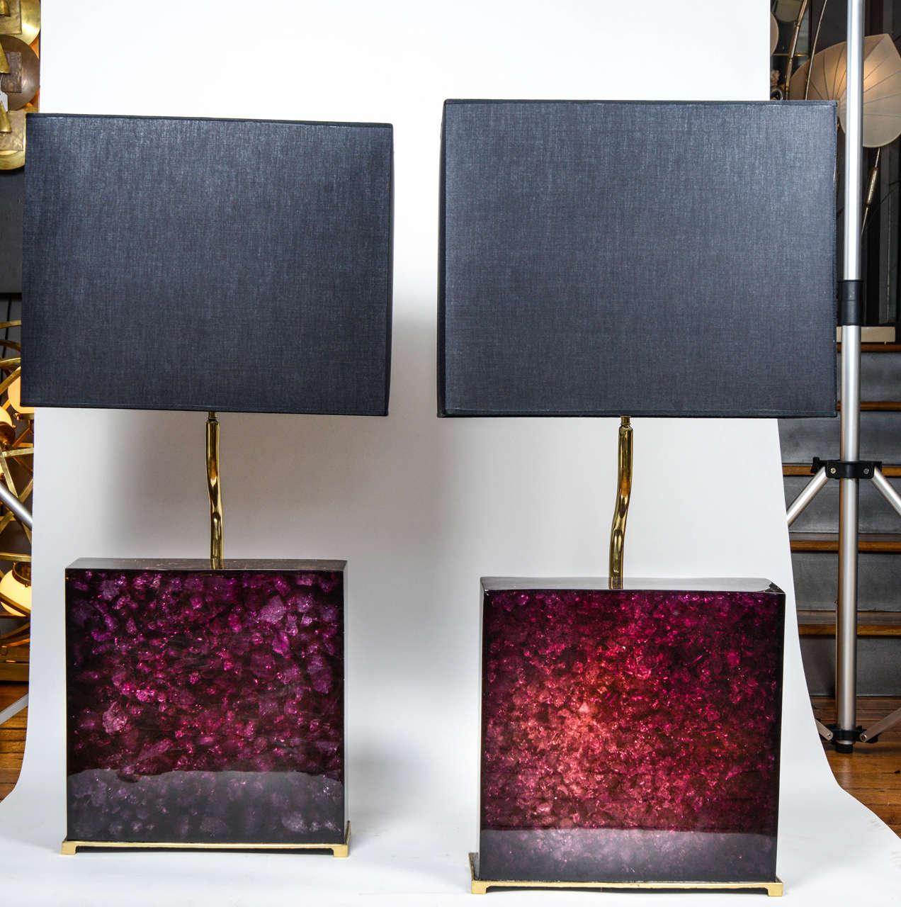 This is a pair of lamps by Enzo Missoni made of crushed Murano glass contained in a big block of purple fractal resin sit on gilded bronze feet. The lamps are both signed 