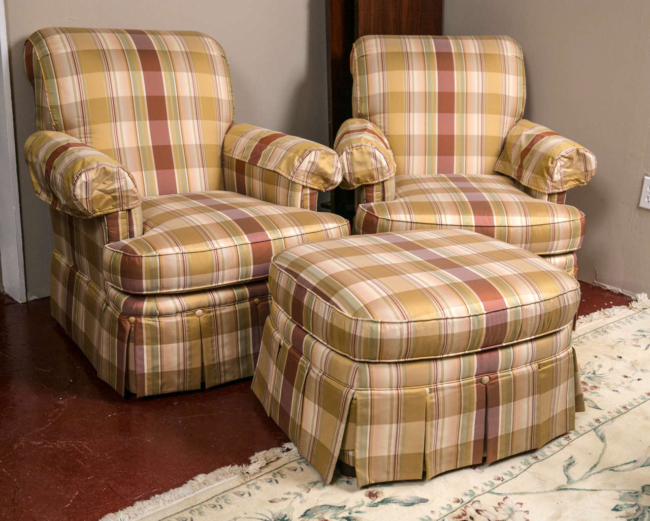 A pair of custom quality silk upholstered plaid club chairs and ottoman. In a sensuous silk fabric with buttoned and pleated bottoms. Soft cushion adds comfort along with style. Great for a reading room or any room that needs a comfortable seat.