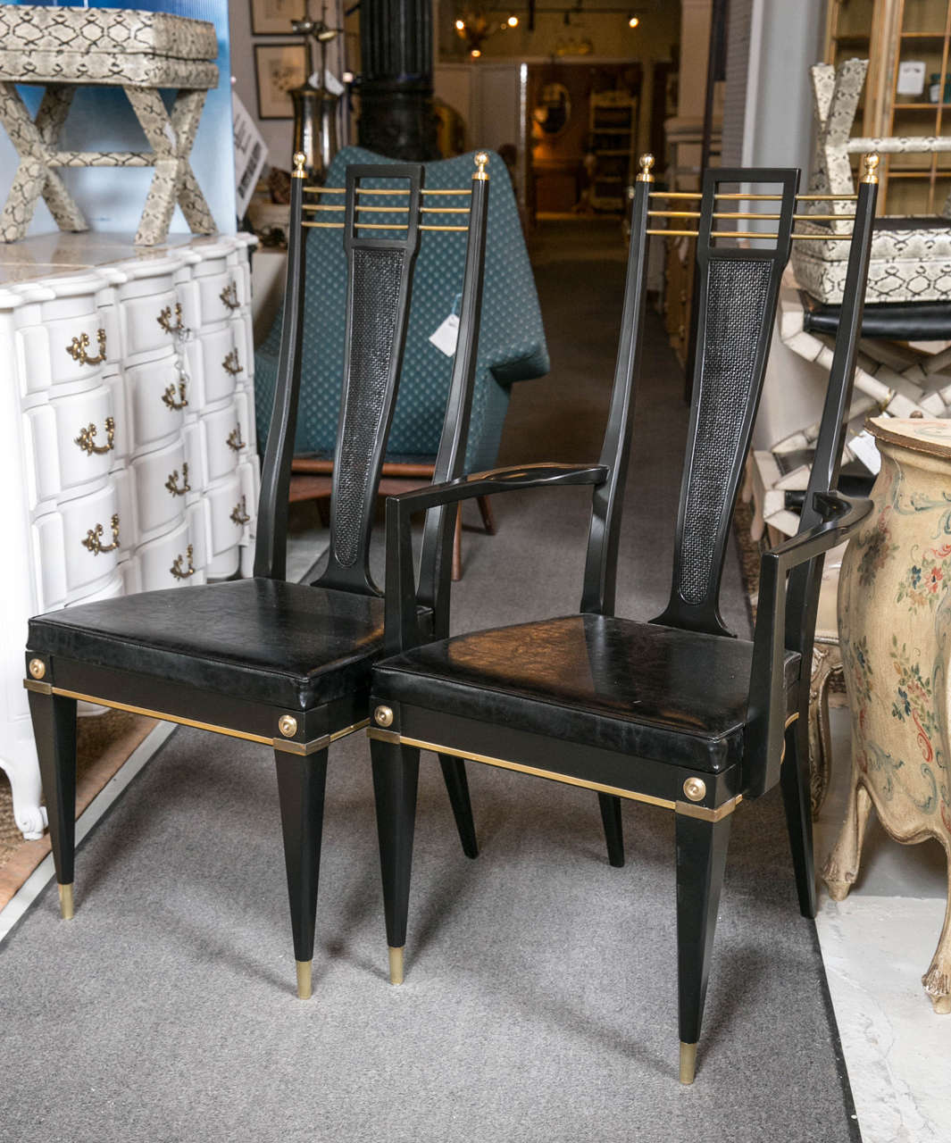 Simply the finest Set of Six Maison Jansen Style Hollywood Regency Bronze Mounted Dining Chairs. The set having bronze rounded sabots leading to rectangular tapering leg. The apron with a bronze framed border and circular bronze mounts under a black