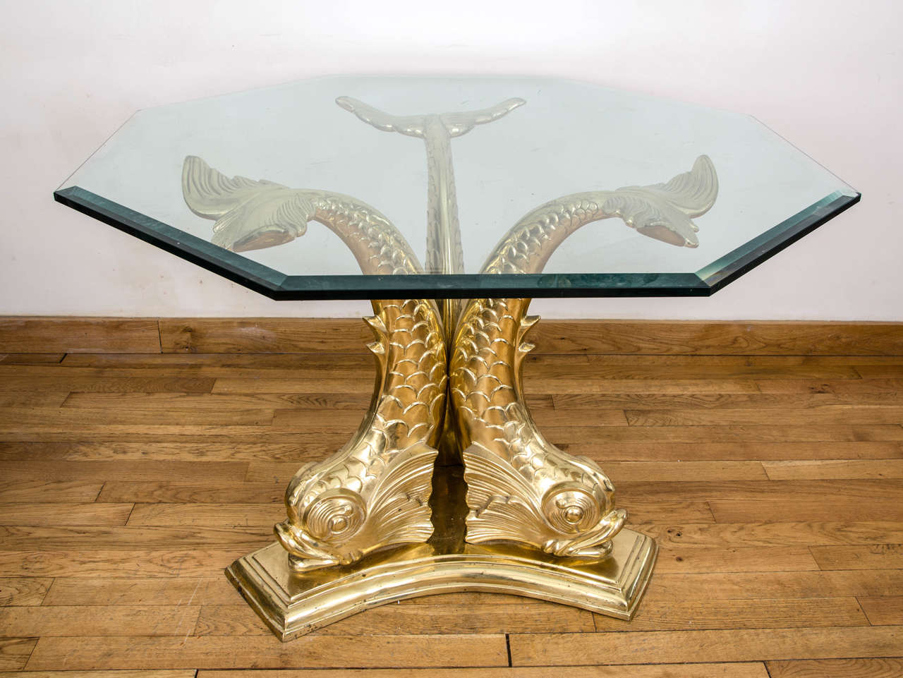 Beautiful cast brass and glass dolphin dining table.
Thick octagonal detachable glass tabletop.