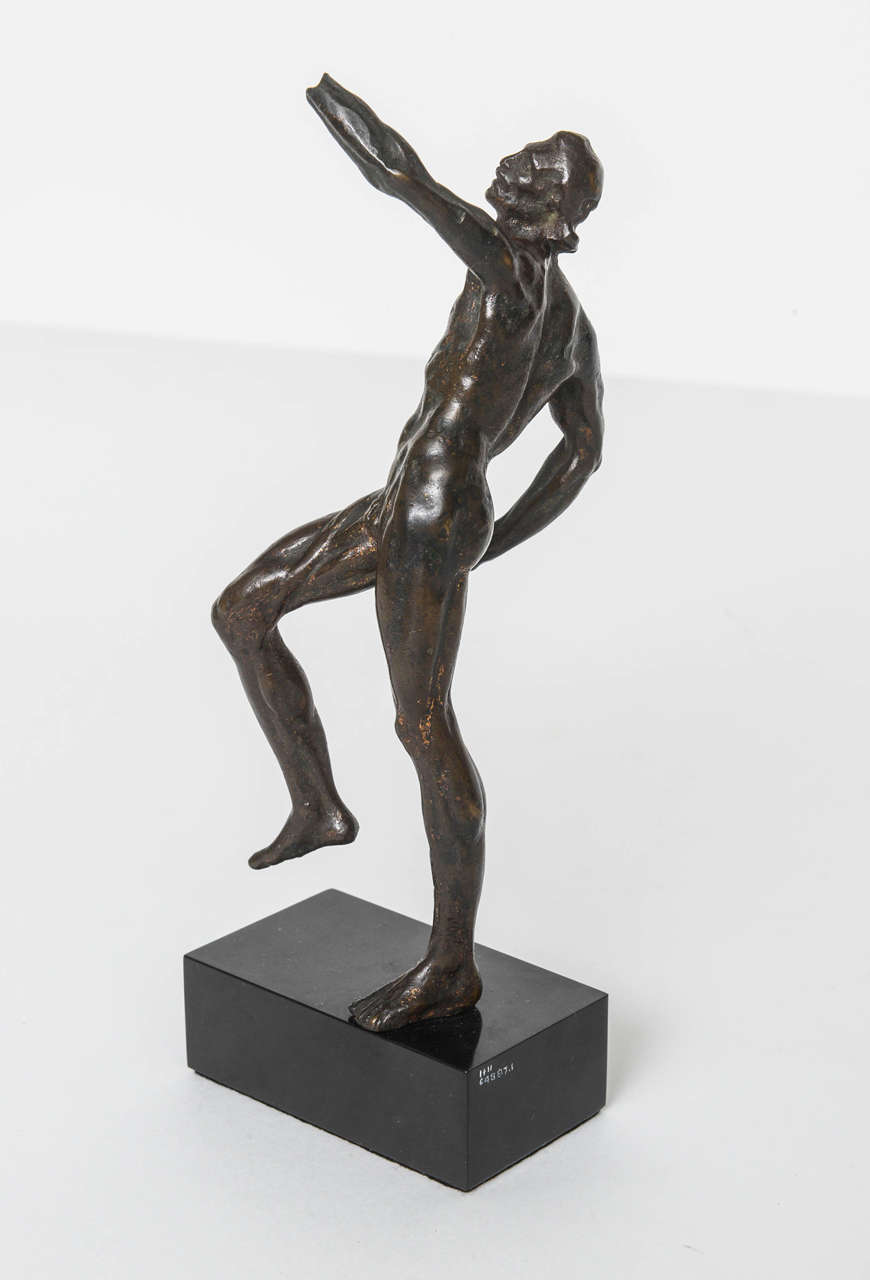 After the model by Pierre (Pietro Francavilla) de Francheville) (1548-1615)  This energetic model of an athlete in motion has finely detailed musculature.  The patina is a rich brown typical of early European bronze statuettes.  The left hand is