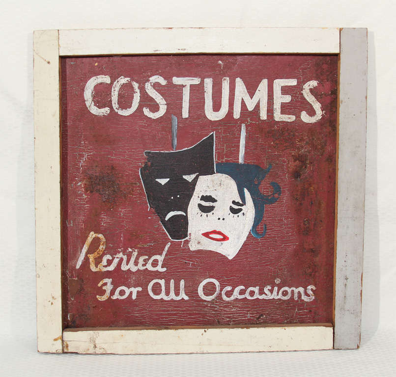 This irresistible crackled-paint, make-do old sign came from a Tennessee costume shop back in the day.  An old painted pine frame was added some time later.  Quirky and cute,  with stylized thespian faces and the phrase 'Costumes - Rented for all