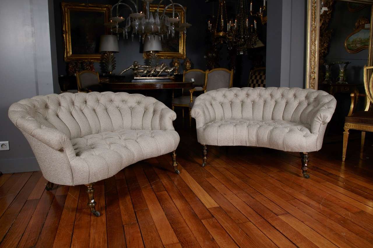Pair of French sofas, bean shape, padded seat and back, four turned wood feet on casters, entirely restored, Nobilis sand color fabric