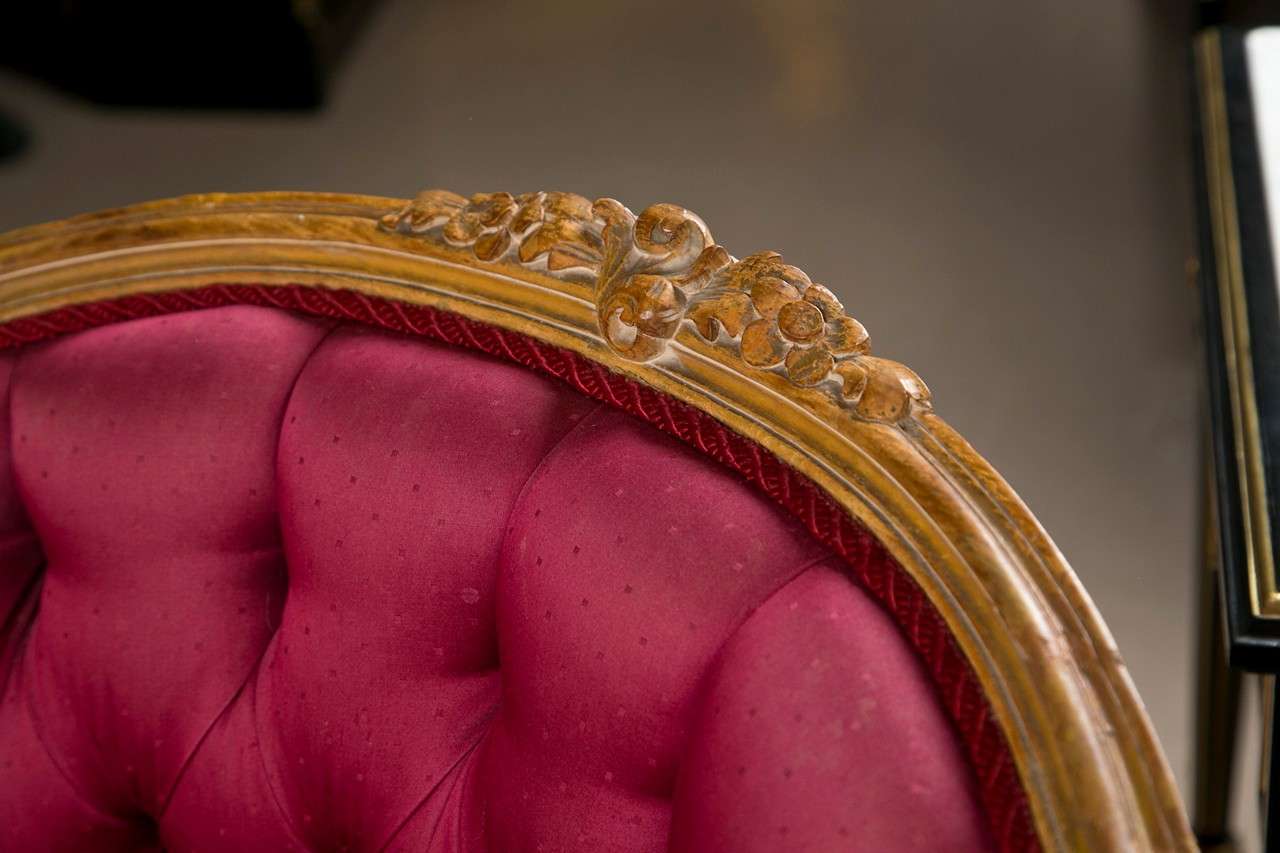 Pair of glamorous French Louis XV style Bergere chairs, natural wood frame, domed back, down-swept arms, tufted back and cushioned seat, raised on cabriole legs. 