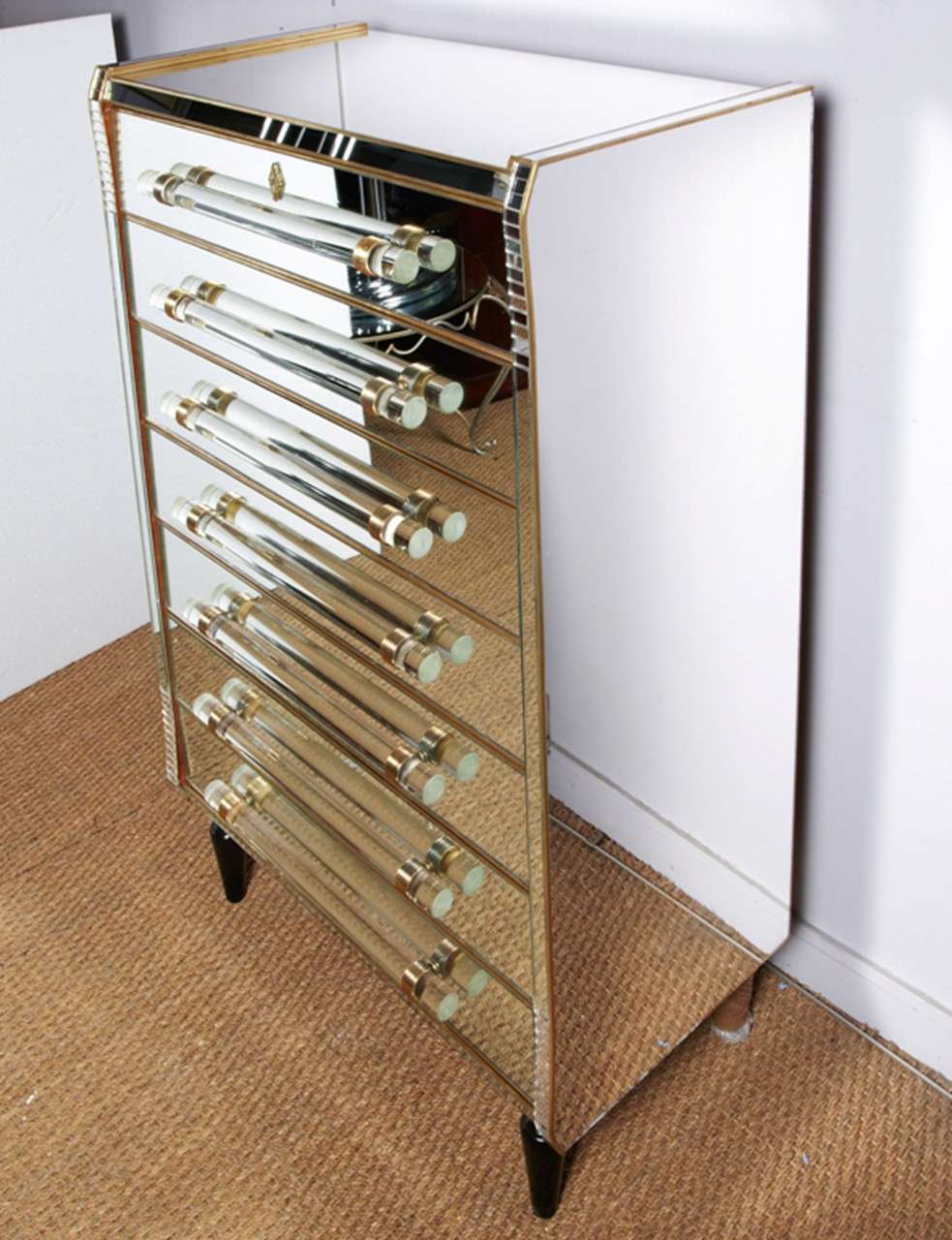 Commode with seven drawers all in mirror.