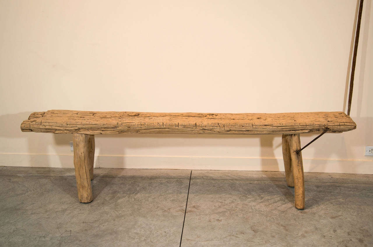 A beautifully weathered elm provincial bench with iron strap and wishbone legs.  From Shandong Province, circa 1850.
