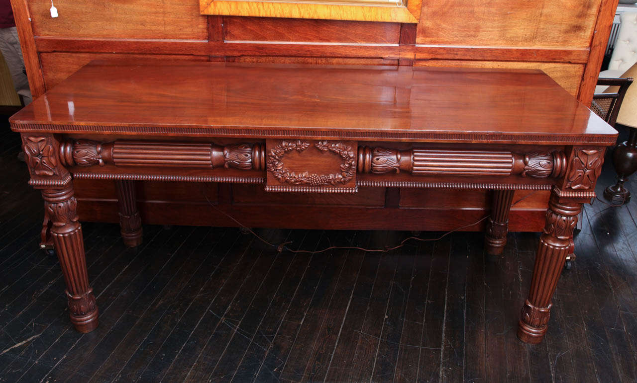 Early 19th century Irish, carved mahogany, two-drawer console table.