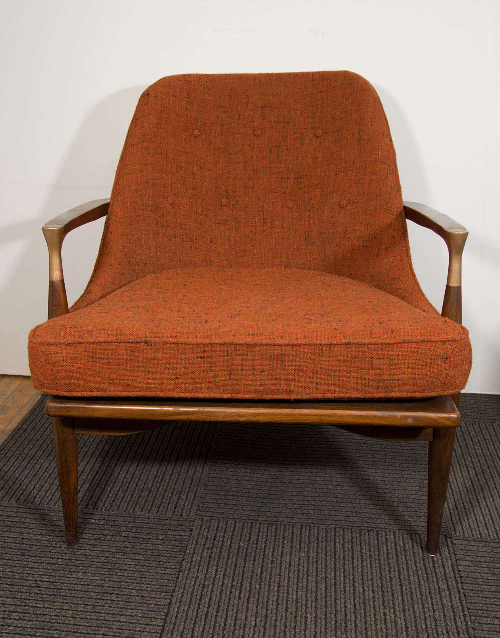 A vintage pair of Ib Kofod Larsen style lounge or armchairs with brass arm-joint detail and original orange upholstery.  In good condition with age appropriate wear.  Some minor scratches on the legs.

Reduced from: $7,500