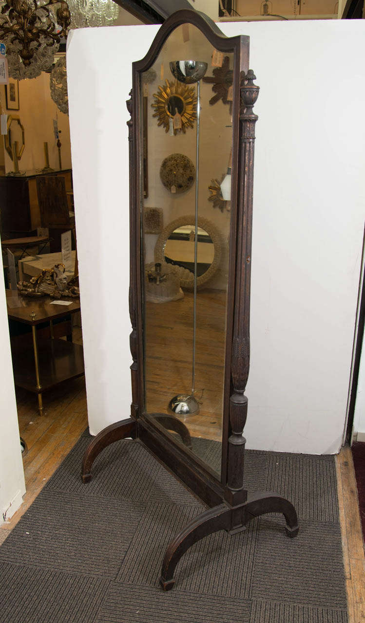 A vintage 1920's wooden full-length Cheval mirror.  Some scratches to the mirror.  The wood is in good condition with age appropriate wear, giving the mirror a 