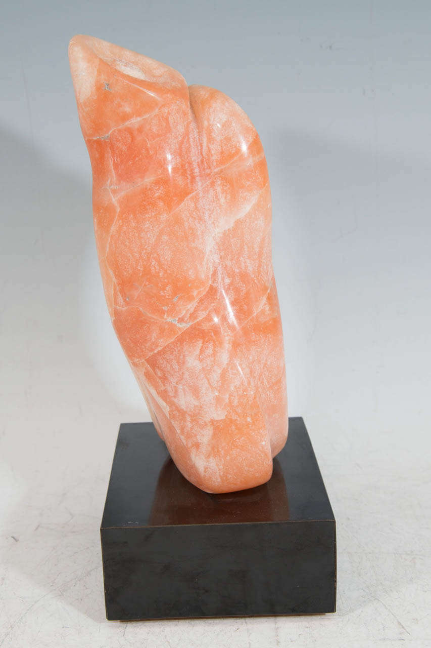 A Coral Colored Stone Sculpture with Revolving Base, Signed ESR 1