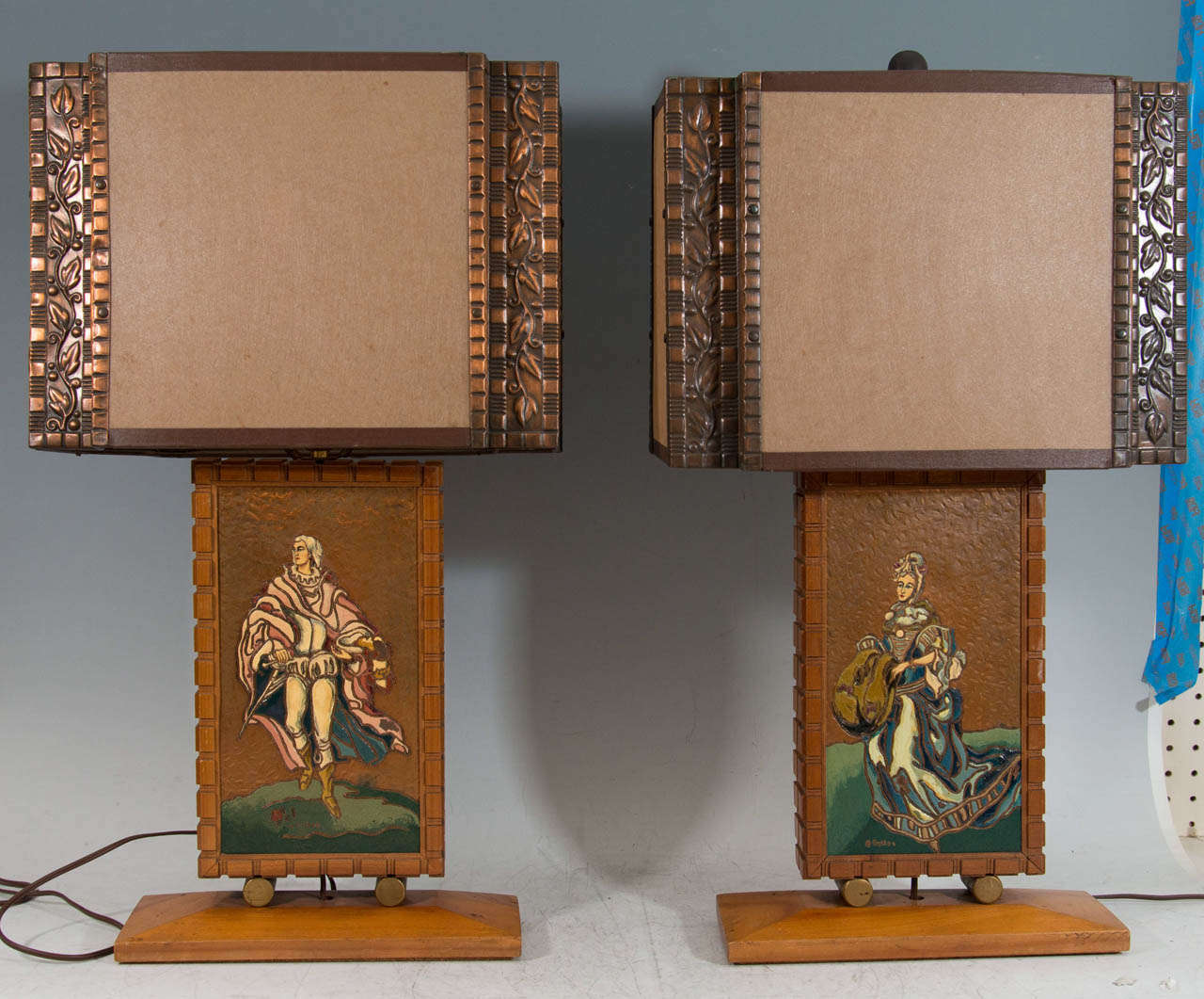 A vintage pair of copper and wood table lamps with male and female enameled figures by Albert Gilles.

Good vintage condition with age appropriate wear.