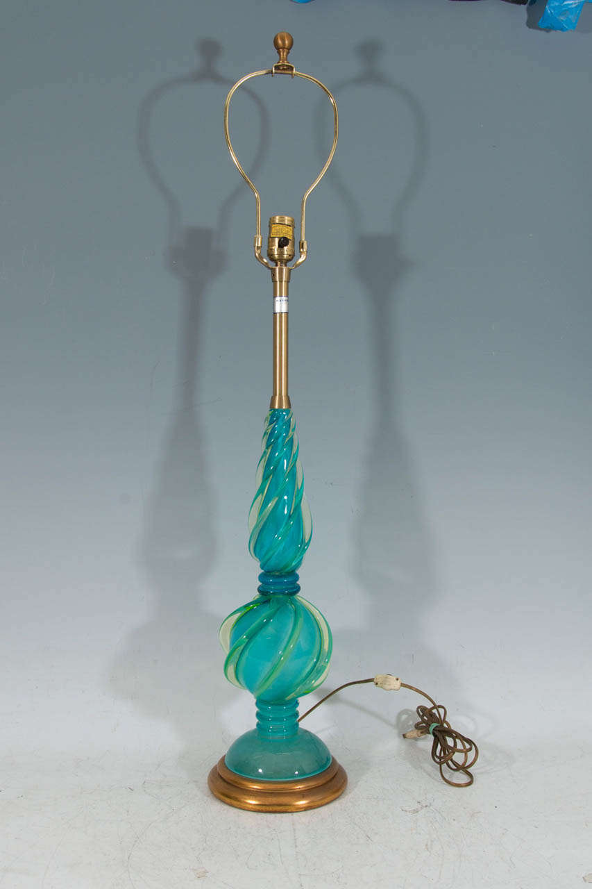 A vintage pair of bluish green or aqua colored Murano glass table lamps on gilt wood bases by the Marbro Lamp Company.  Retains its original label.

Good vintage condition with age appropriate wear.

Reduced from: $5,800