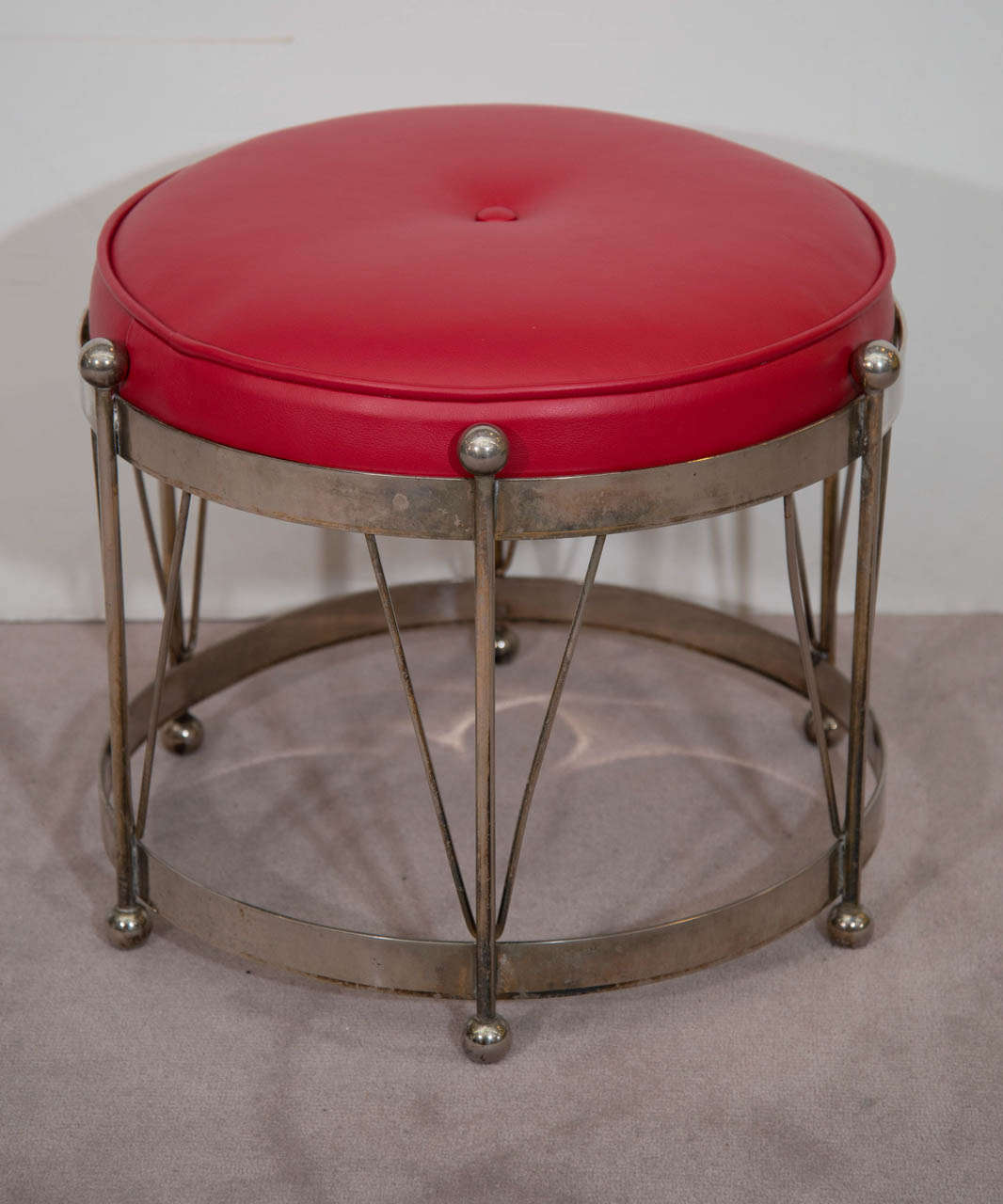 A vintage red leather upholstered drum bench with chrome frame and ball accents.  Good vintage condition with age appropriate wear. Some discoloration and scratches to chrome surface.

Reduced from: $975