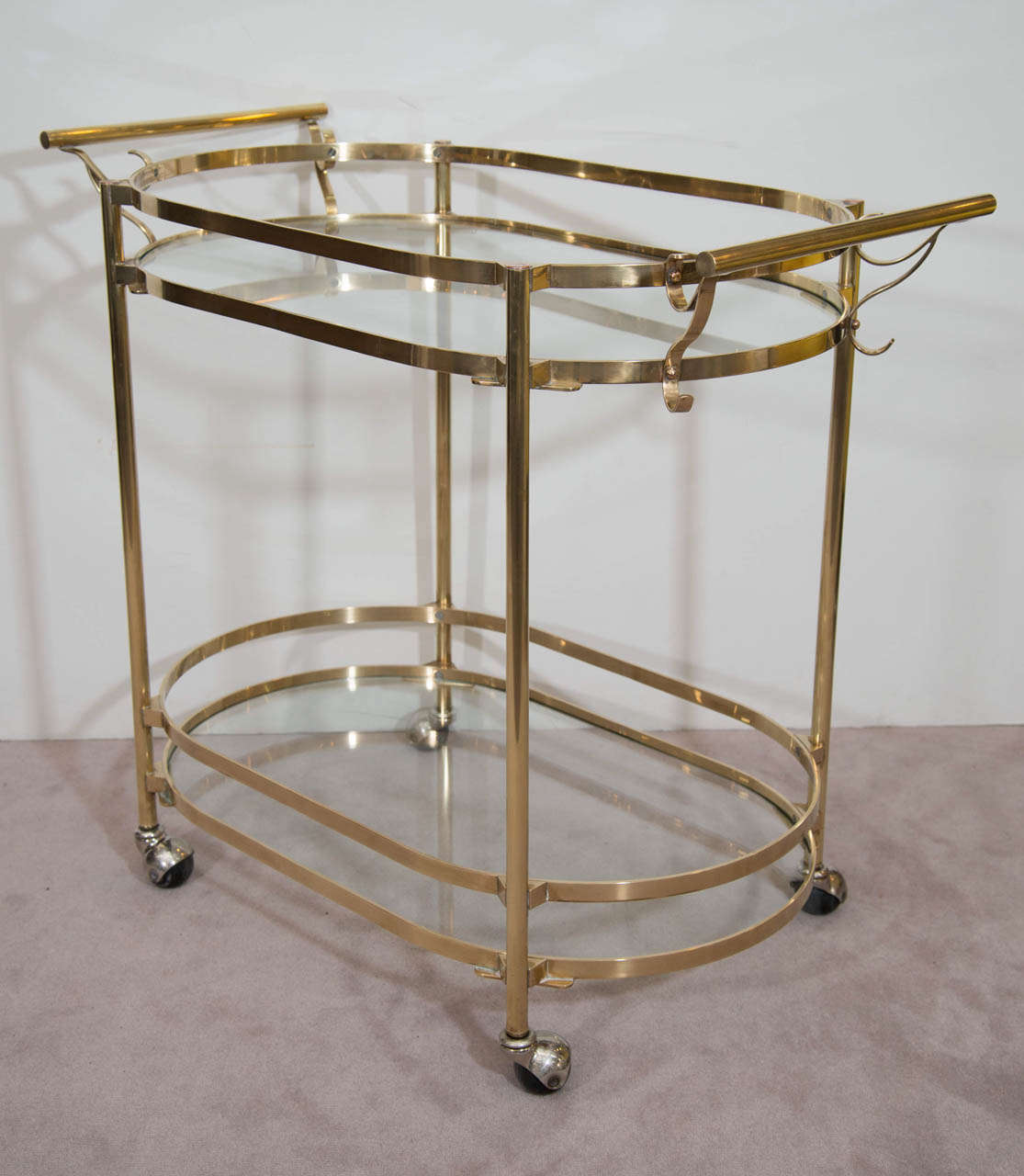 A vintage Italian double-handled brass and glass two-tier bar cart on casters.

Good vintage condition with some wear to the brass.

Reduced from: $1,850