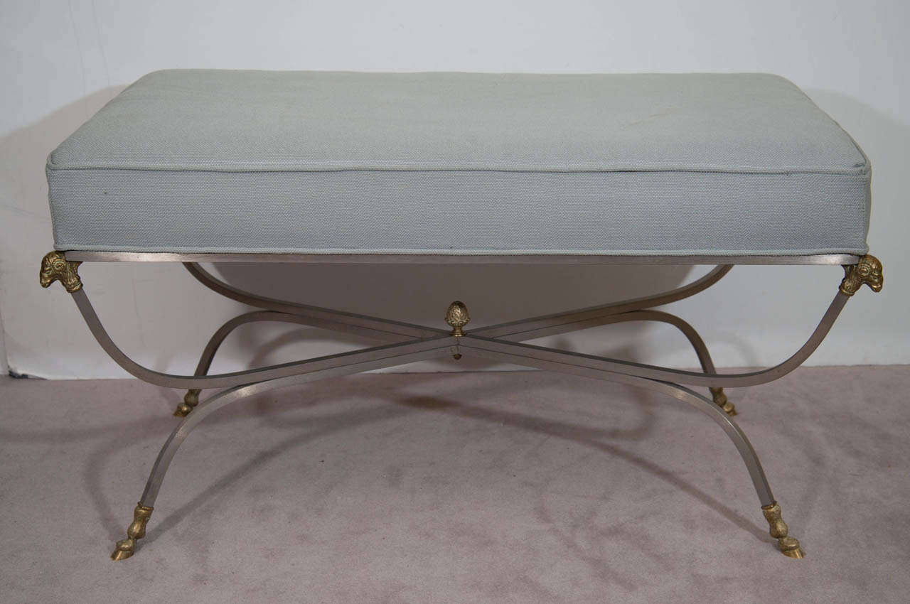 A single vintage bluish gray, chrome and brass extra wide bench with rams heads and hoof feet.

Good vintage condition with age appropriate wear.