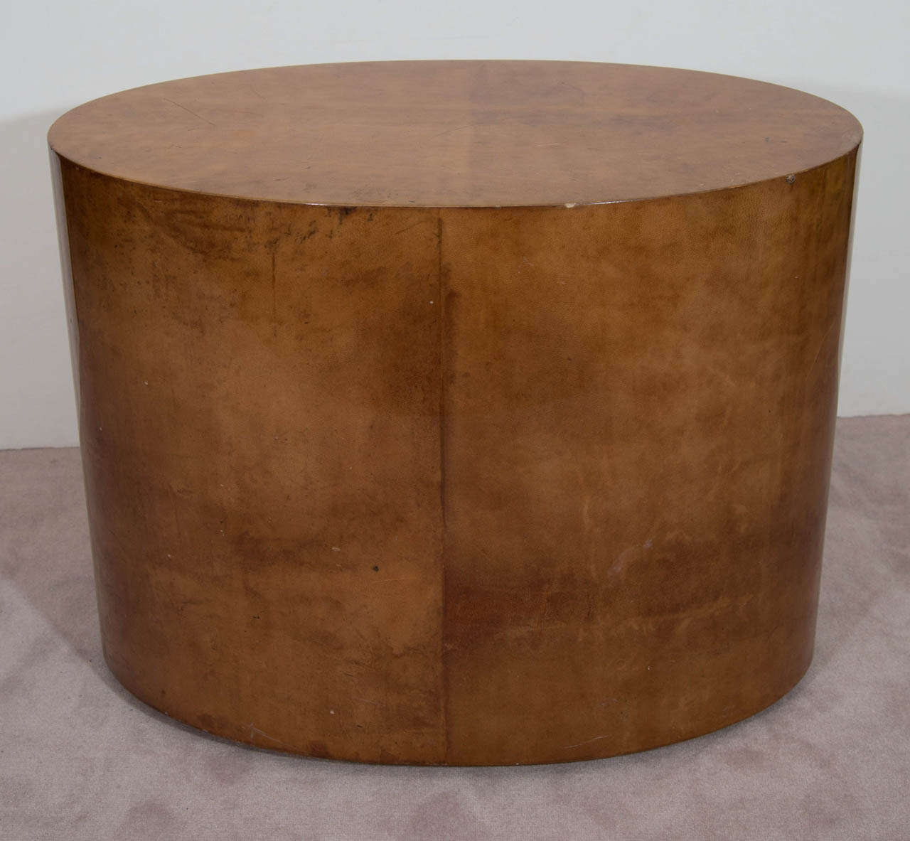 A vintage oval coffee or cocktail table made of lacquered goatskin in the style of Karl Springer.

Vintage condition with some cracks, wear, and loss.