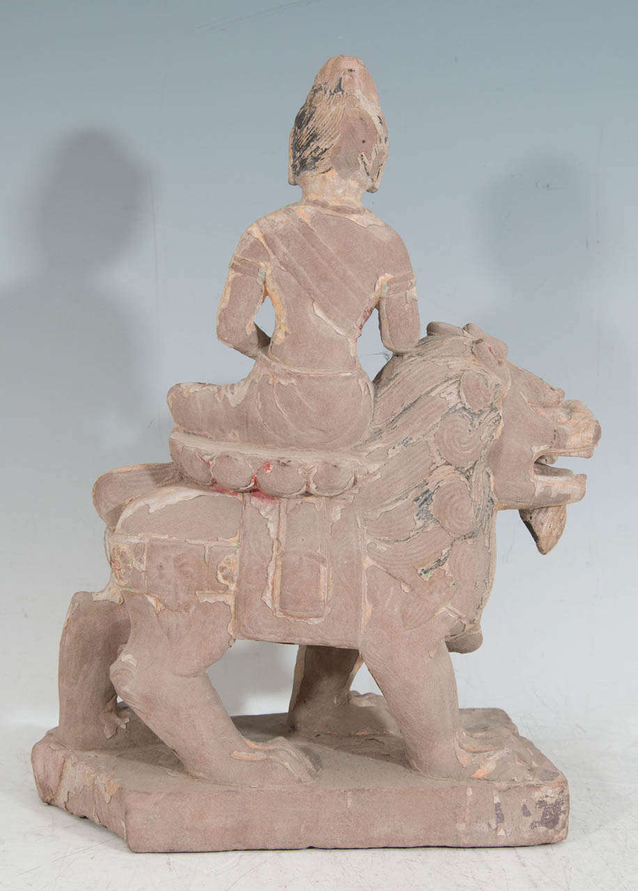 A Tang Dynasty Guanyin Riding on a Buddhist Lion 1