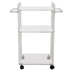 A Three-Tier Lucite Bar Cart on Casters