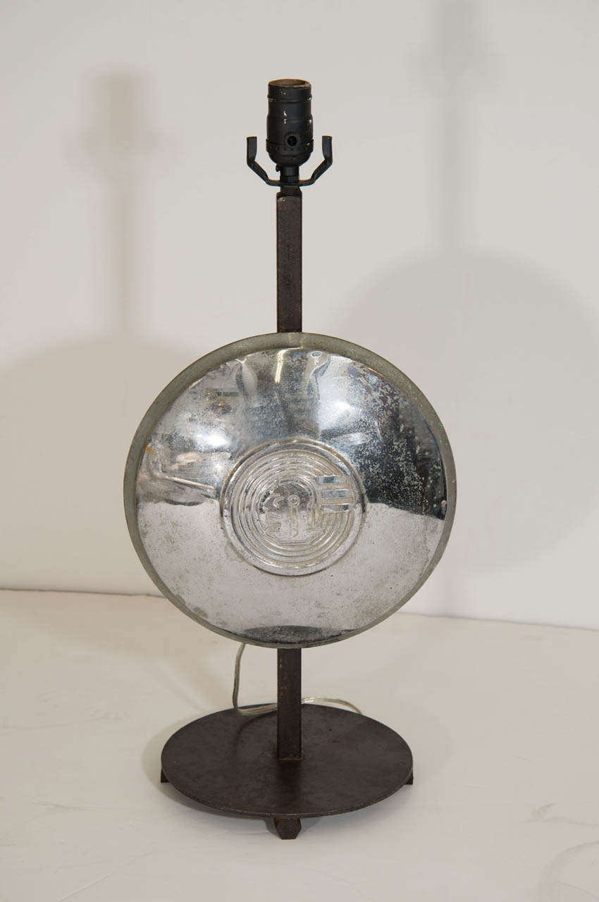 A vintage pair of aluminum hubcaps mounted on iron bases and made into table lamps.

Vintage condition with wear and denting to the aluminum and wear to the iron