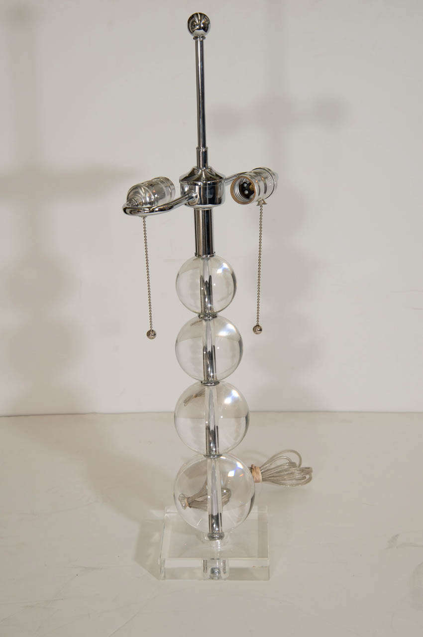 A vintage pair of glass and chrome stacked four ball table lamps.  The balls are in ascending order.

Good vintage condition with age appropriate wear.