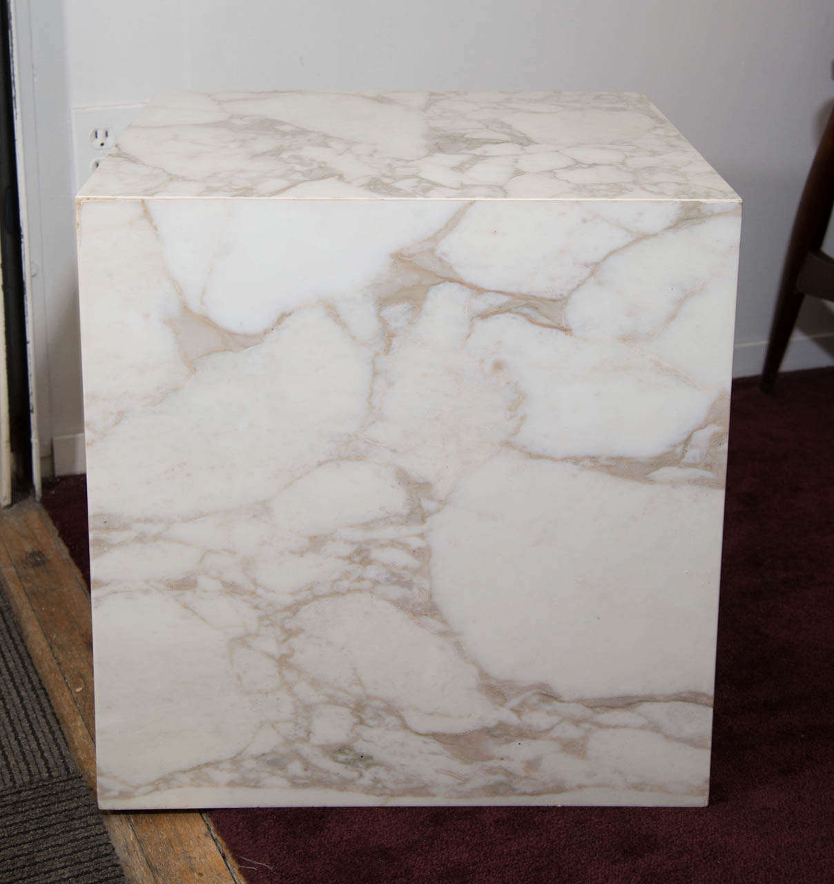 A vintage pair of cube shaped solid marble slab end or side tables with dark veins on casters. 

Vintage condition with a few chips to the marble