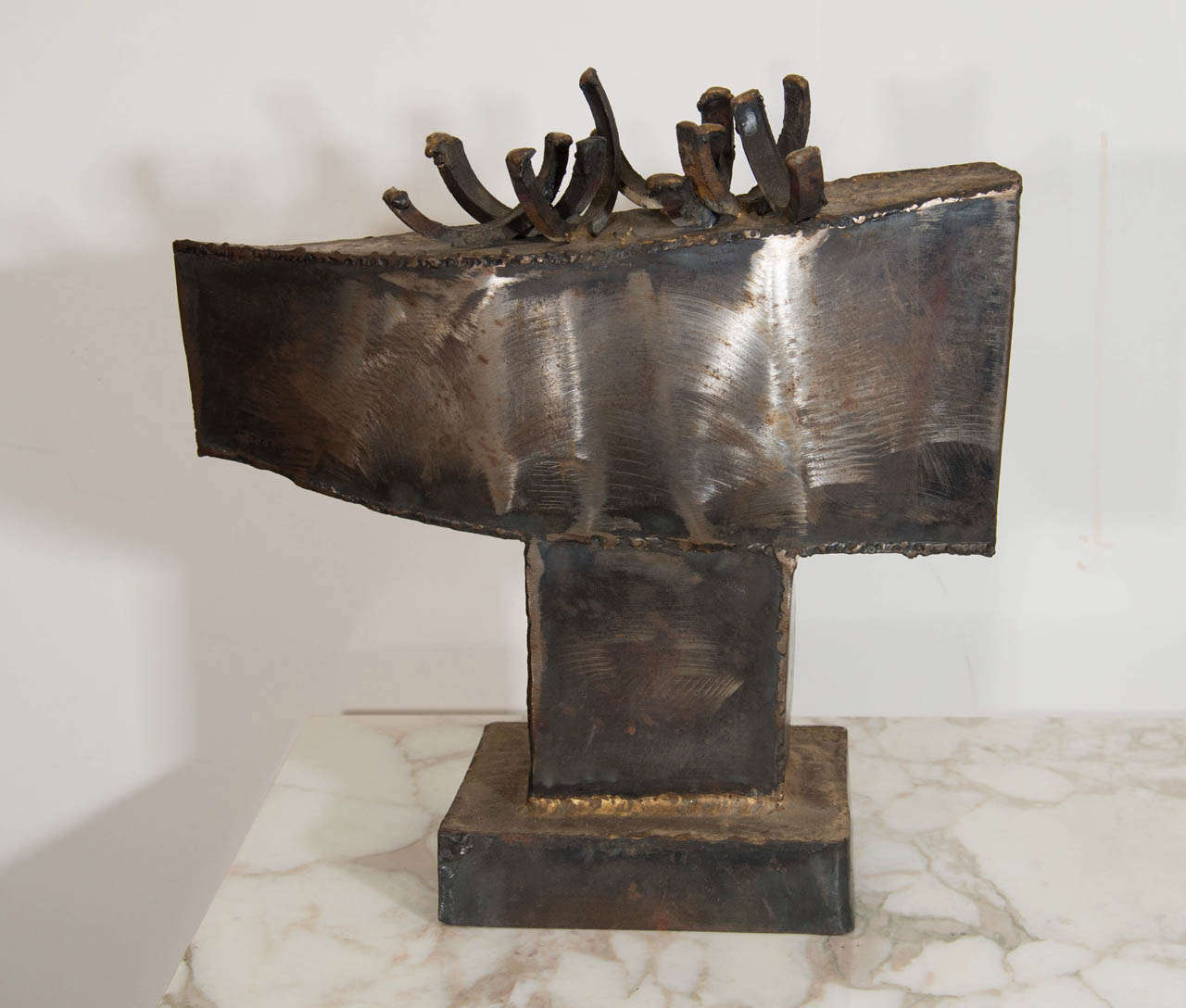 A vintage abstract, Brutalist sculpture made of welded steel and gilded solder in the style of Paul Evans.

Good vintage condition with age appropriate wear.