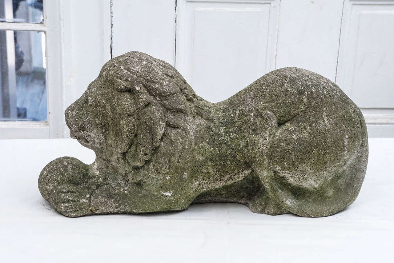 This garden element formed as a lion recumbent is crafted in cast stone then hand finished to give it  detailed modeling and character Purchased from an Up state New York Garden  created beginning in the 1890's and worked on thru until the late