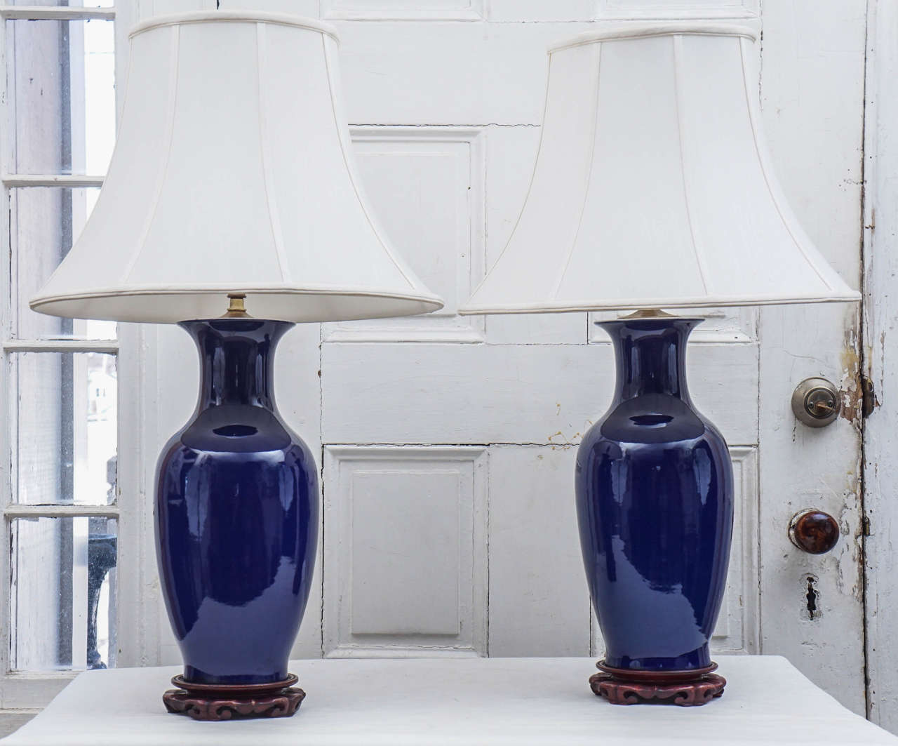 This lovely pair of lamps made from old Chinese porcelain vases in an  over all monochromatic rich deep blue glaze are of good quality and a nice large scale   (mounted as lamps the height  to the top of the shade provided is 28.50 inches). The