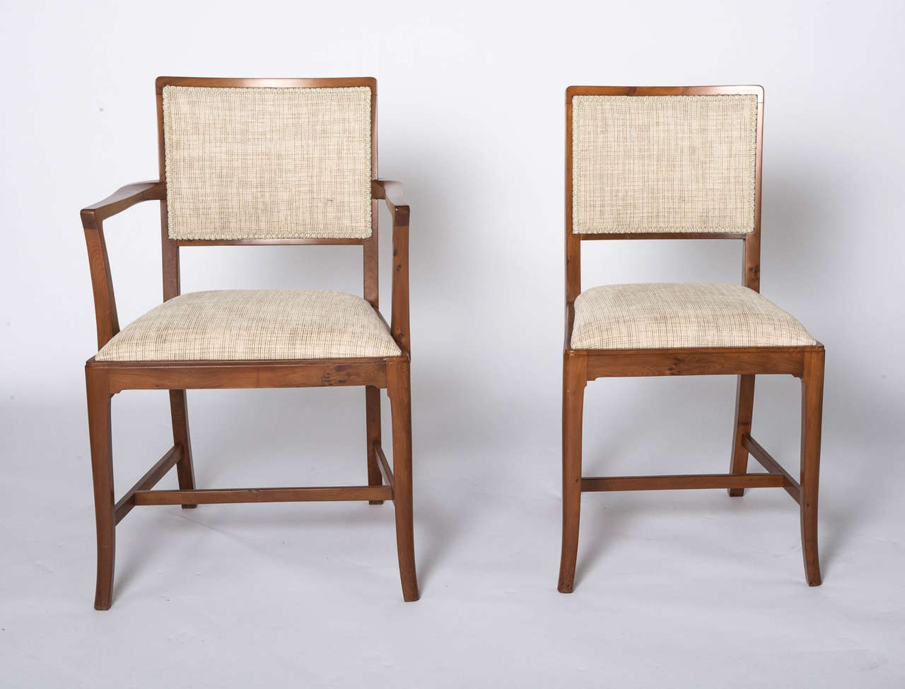 A set of eight Yew Dining chairs by Heal and Sons of London.
Comprising 6 standard and 2 carvers.
Some with ivorine circular plaque.
England, circa 1930.
Singles 48cm w x 46cm d x 90 cm h 
Carvers 58cm w x 46 cm d x 90 cm h