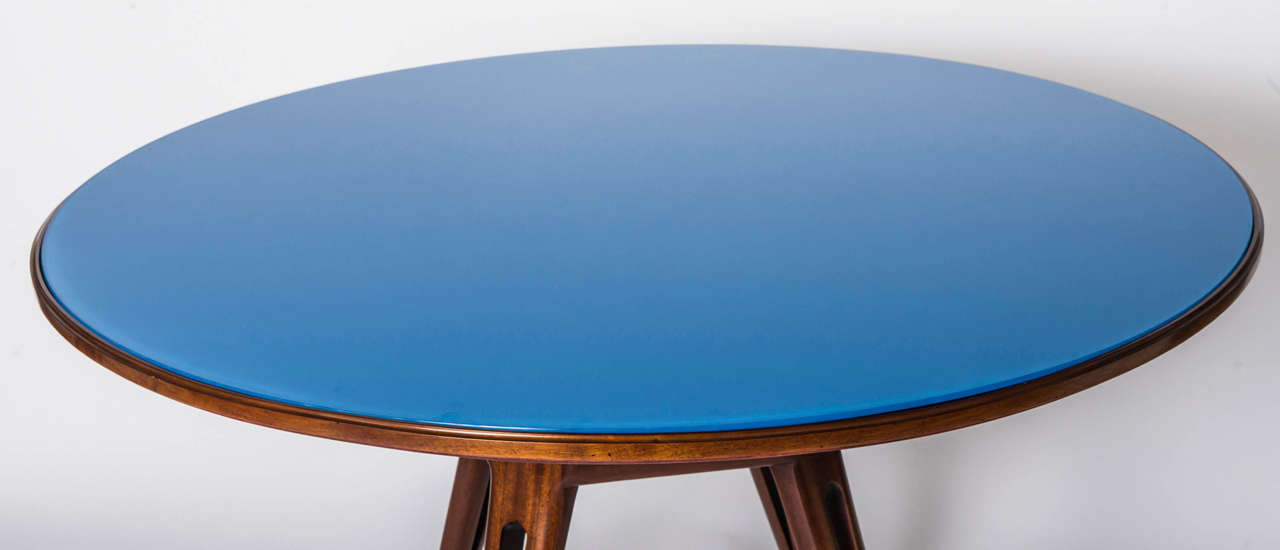 An Osvaldo Borsani Mahogany centre Table.
The circular top set with blue glass top. Raised on an outswept pierced stand leading to four pierced outswept legs.
Italy circa 1950
118 cm diamer x 80 cm high