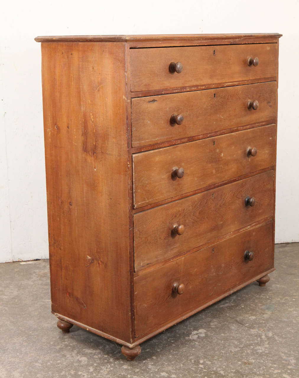 Vintage American chest of five drawers with turned wood knobs.