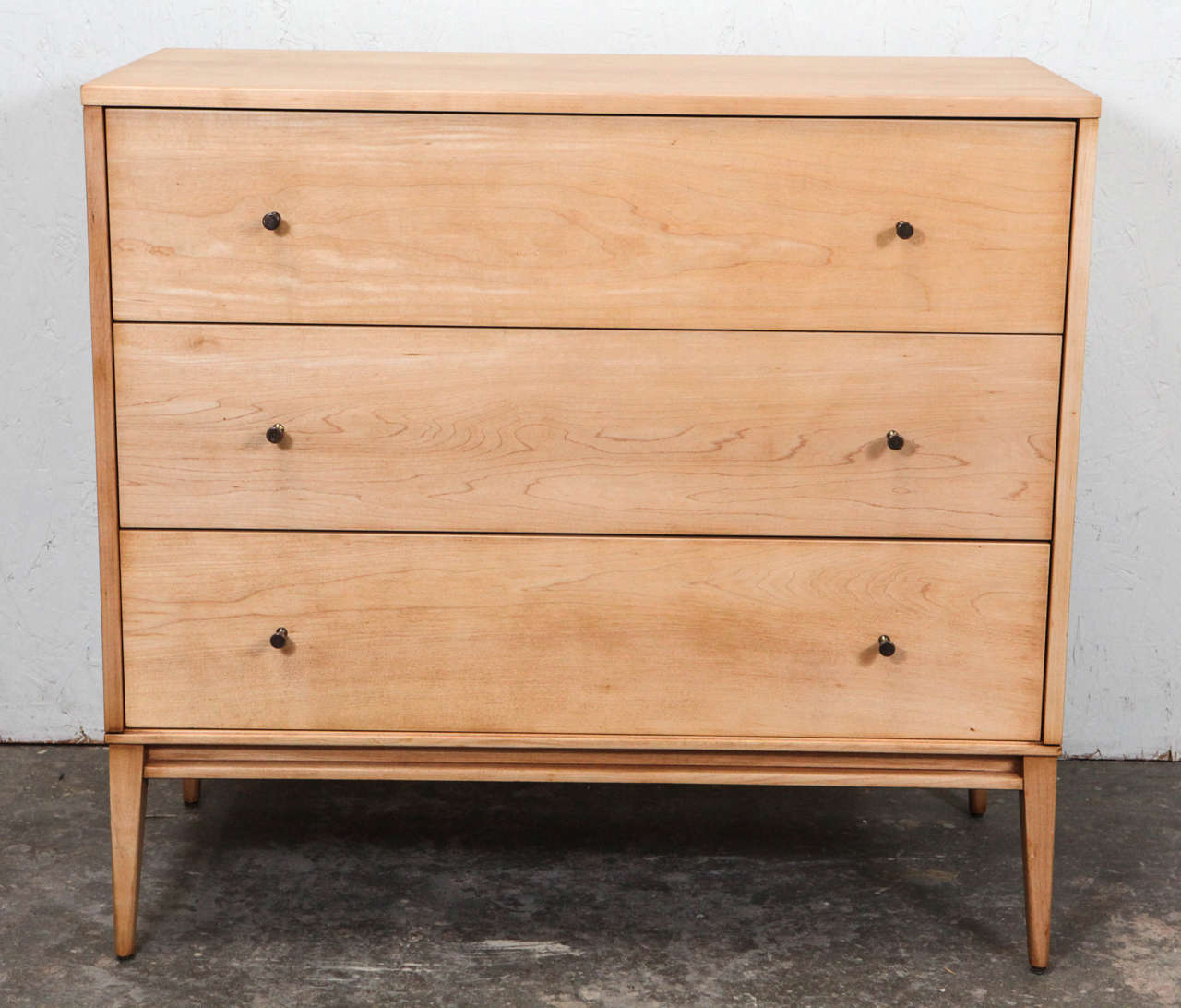 Handsome mid-century dresser in bleached oak featuring original Paul McCobb drawer pulls.